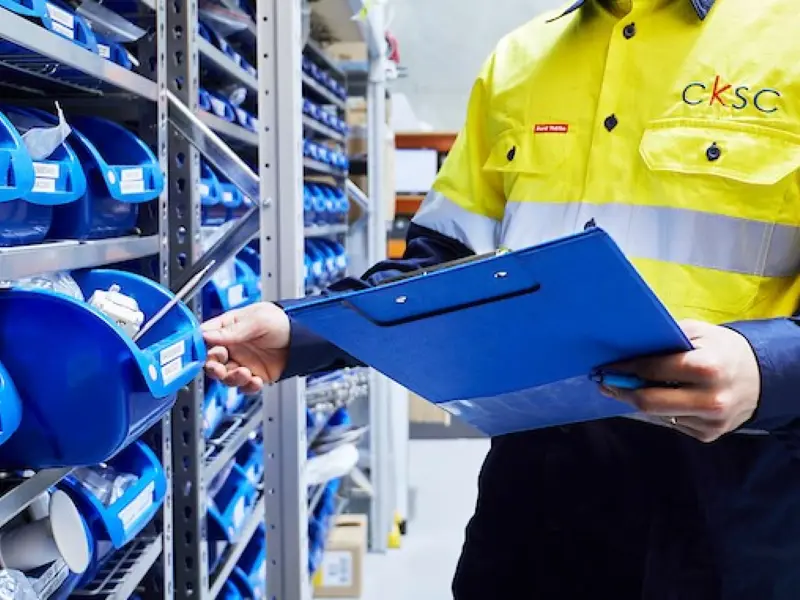 middle shot of man performing an inventory check. 
